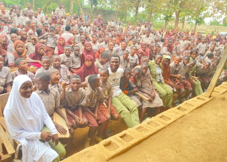 Reinforcing Hope and Community Learning in Odopetu Ghetto A cross section of Kehinde Benson Ilegbusi leading a group of NYSC members of the Education Community Development Group at Community Primary and Secondary School in Egbeda ghetto southwestern Nigeria under the project: "#Hope for Street Children and Community Learning Programs in Southwestern Nigeria." 10 February 2023. Photo credit: Ilesammi Oladipo and Samuel Idowu Ilegbusi.